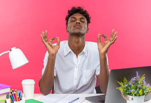 Man practicing relaxation techniques at work to reduce stress