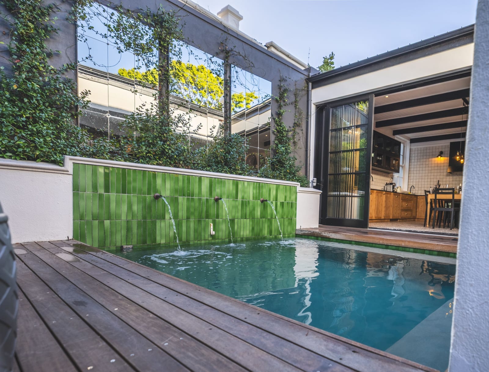 Private pool and deck with a green tiled water feature, Cape Cadogan Villa