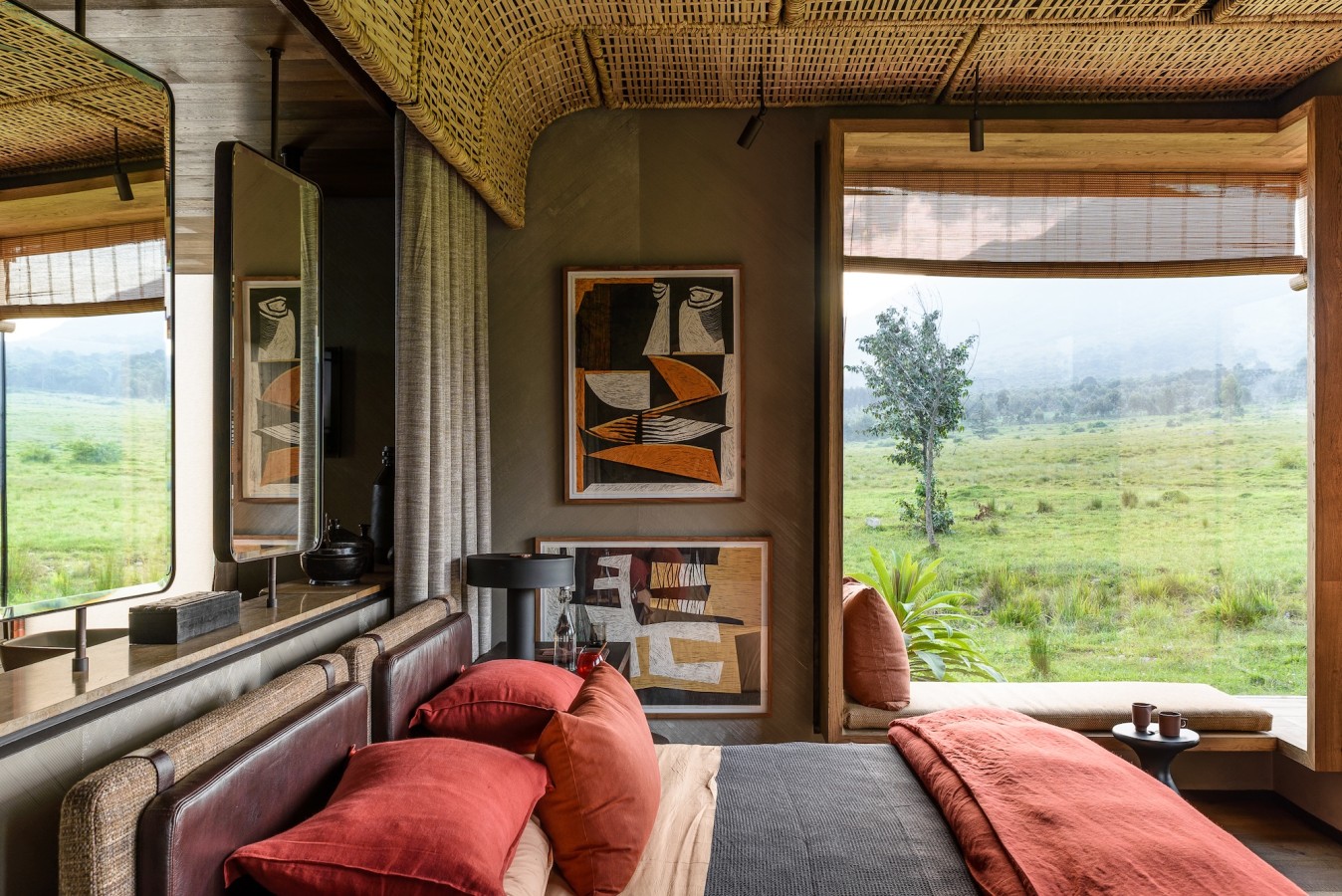 Kwitonda Interior of one bedroom suite with dark orange bedding at Singita Kwitonda Lodge