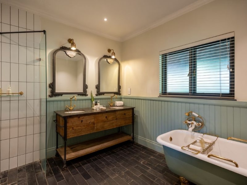 Garden View Suite bathroom with a freestanding bath, walk-in shower and twin mirrors