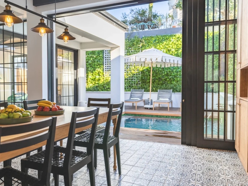 Dining table opening onto the pool, Cape Cadogan Villa