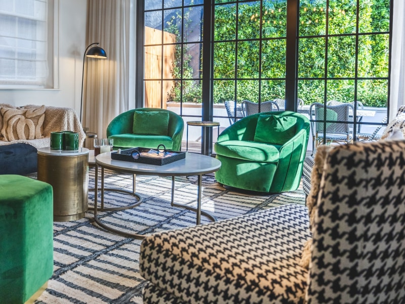 Lounge with green velvet chairs, Cape Cadogan Villa
