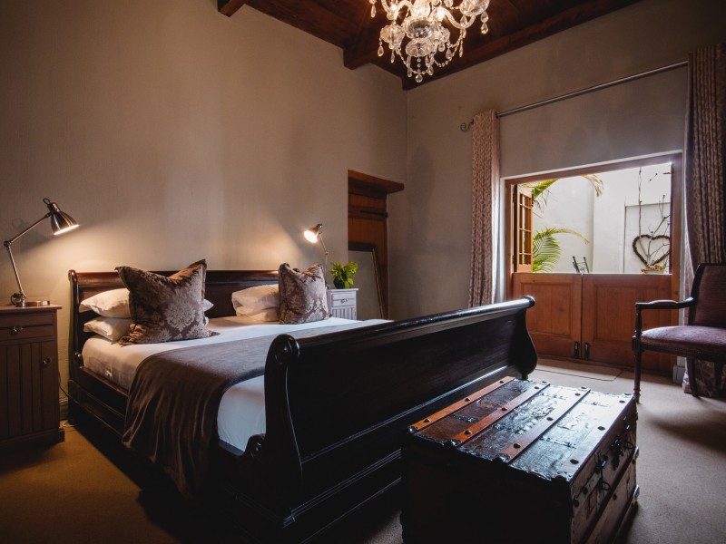 Bedroom with antique sleigh bed and chandelier