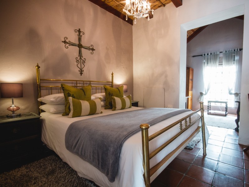 Country Room brass bed and sitting room beyond