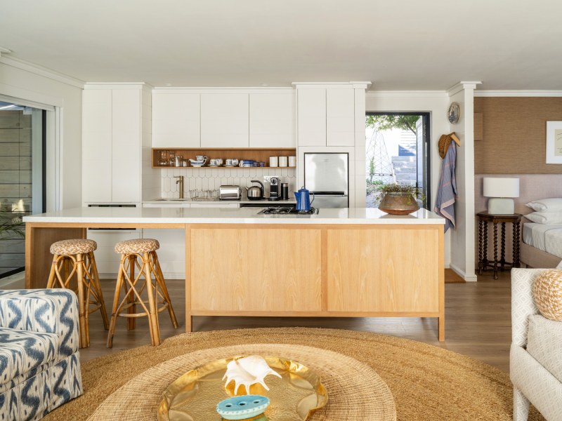 Kitchen island and bar stools, looking through to the bed
