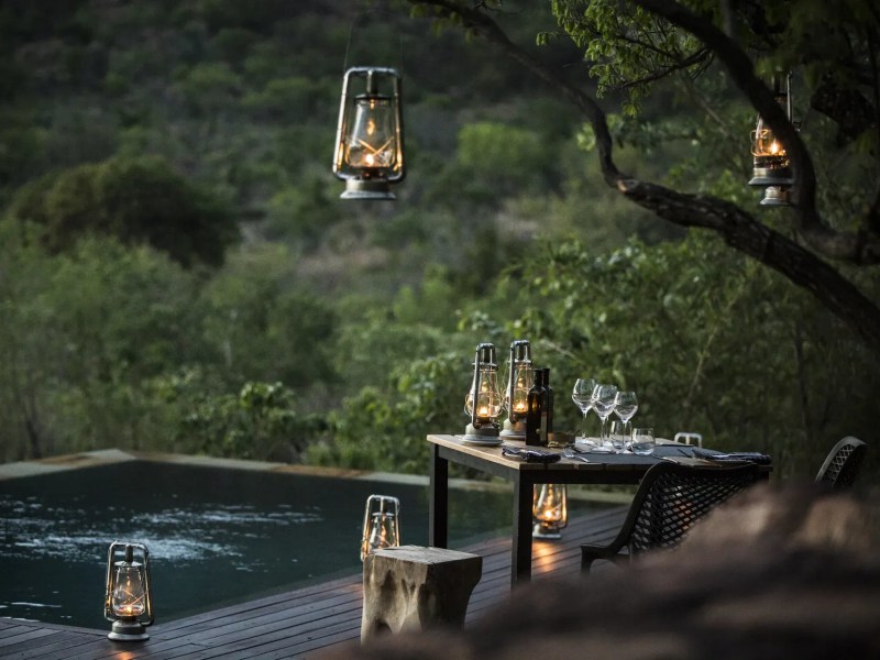 Rock pool lit with lanterns at dusk, Marataba Mountain Lodge