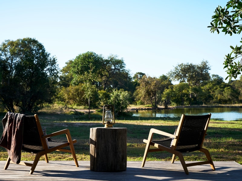 Deck chairs facing the waterhole, Monwana Game Lodge