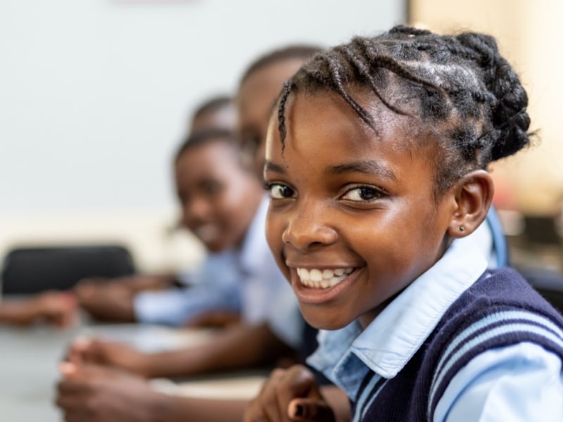 Schoolgirl sitting in class at Singita Boulders Lodge