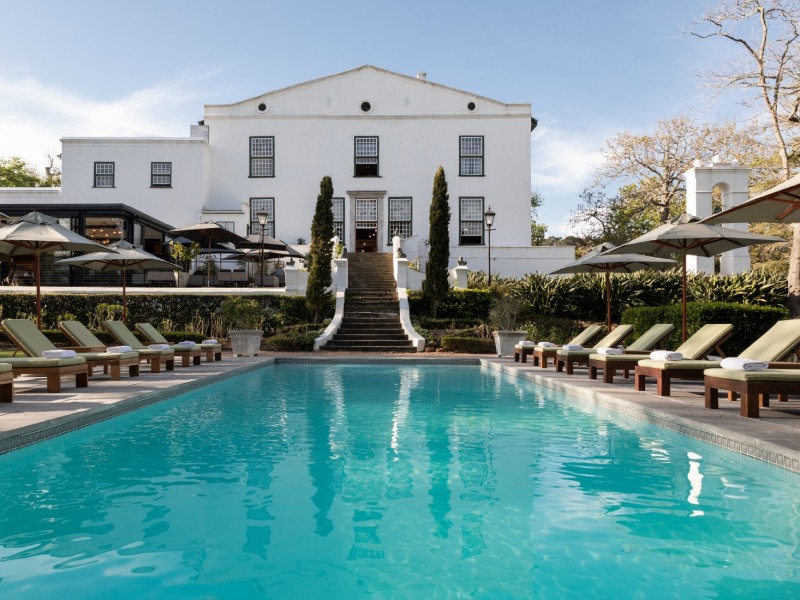 Heated pool with the white manor house behind