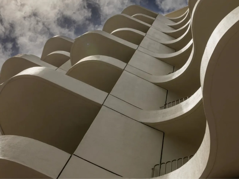 Exterior looking up at the curved balconies
