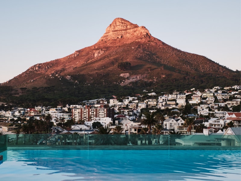 Rooftop pool at sunset reflecting Lion's Head
