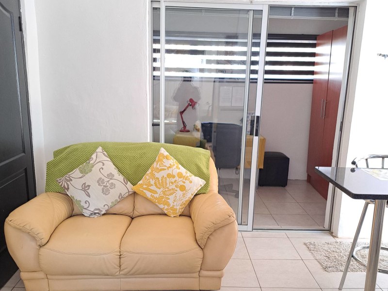 Spacious extra room with cupboards and work space.
