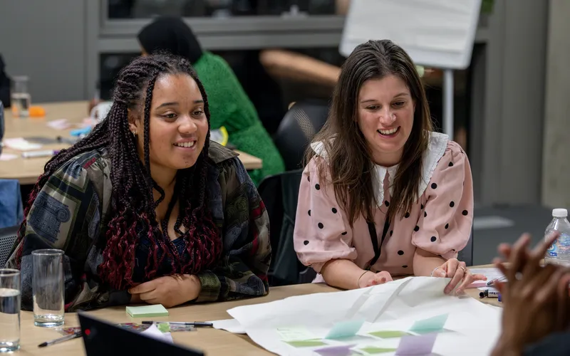 A picture of Iola and Sarah smiling while taking part in a Youth Panel session