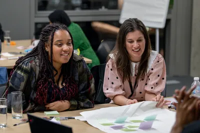 A picture of Iola and Sarah smiling while taking part in a Youth Panel session