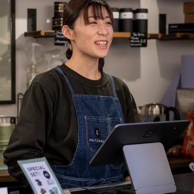 Matchado team member smiles behind serving desk