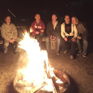 People sitting at central campfire