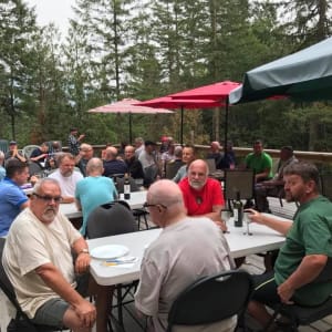 People sitting at event on clubhouse deck