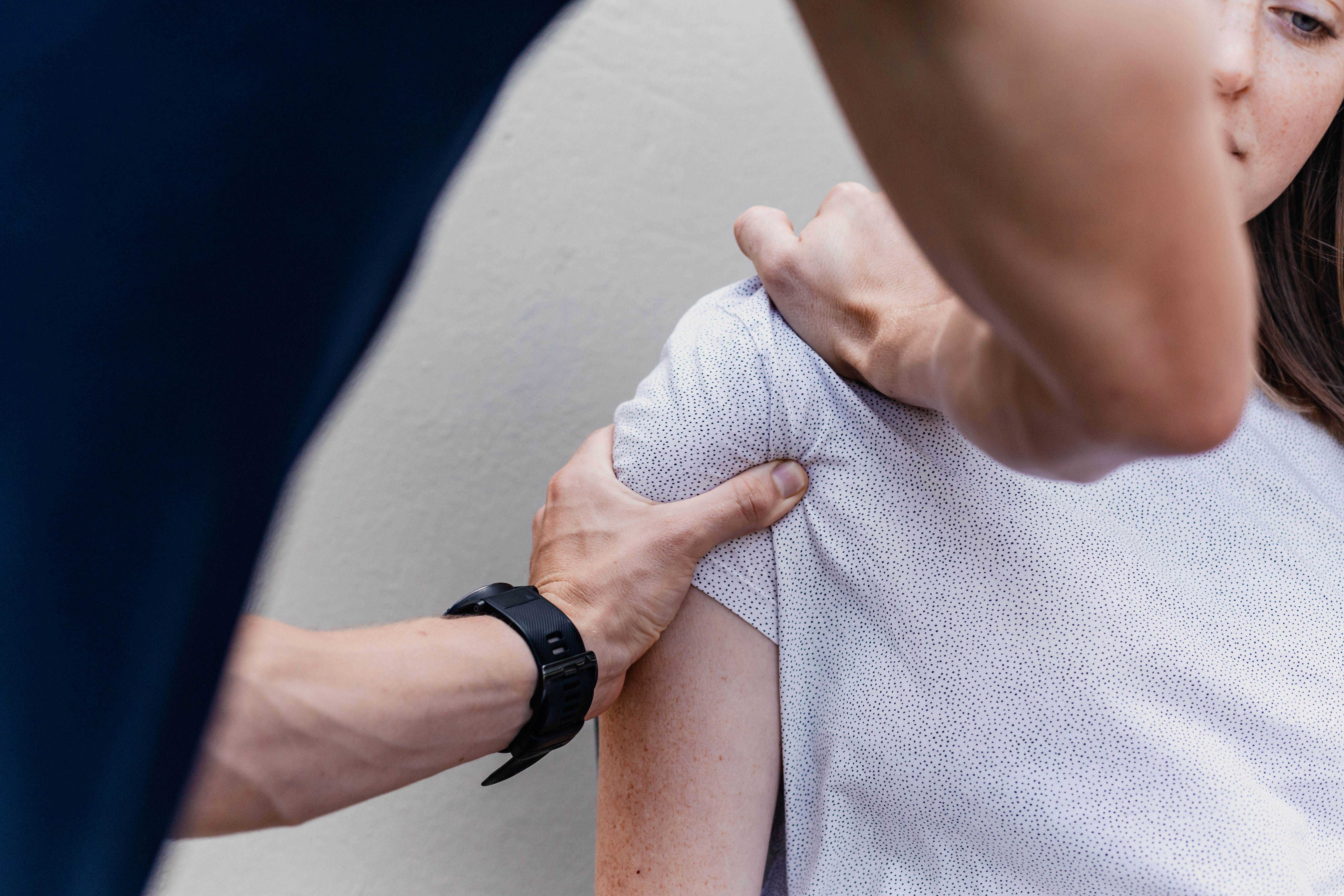 Physiotherapist performing shoulder treatment for rotator cuff disease