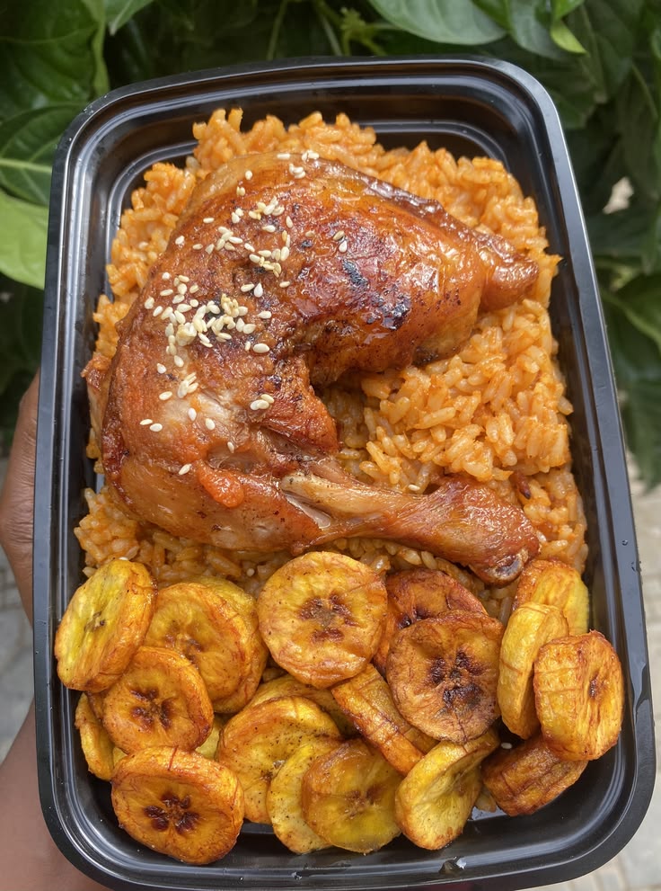 Jollof rice with chicken lap and plantain. image 1