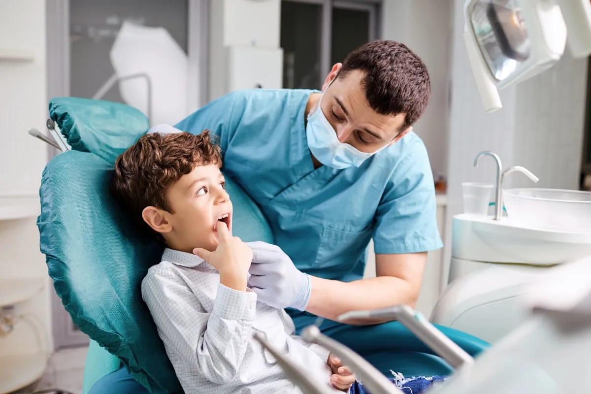 Kids' Dental Exams: Ensuring Healthy Smiles in Plano, TX, Plano, TX Dental hygienist demonstrating brushing techniques to a child