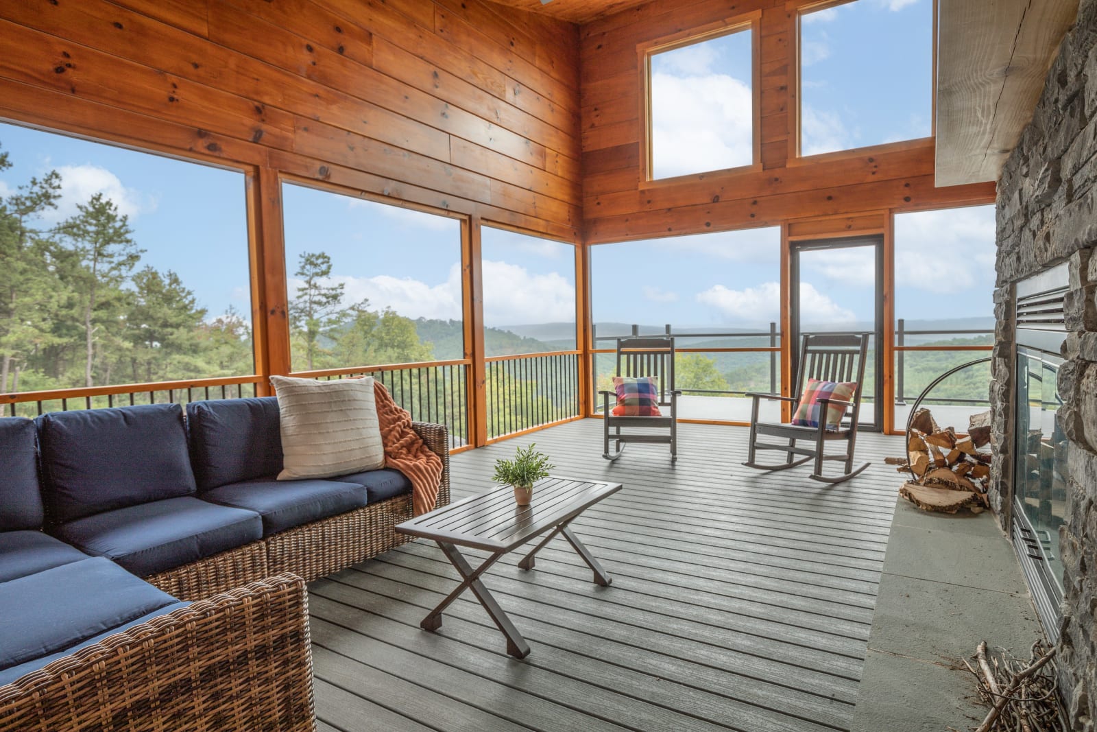 Screened porch with rocking chairs looking out over the mountain valley at golden hour