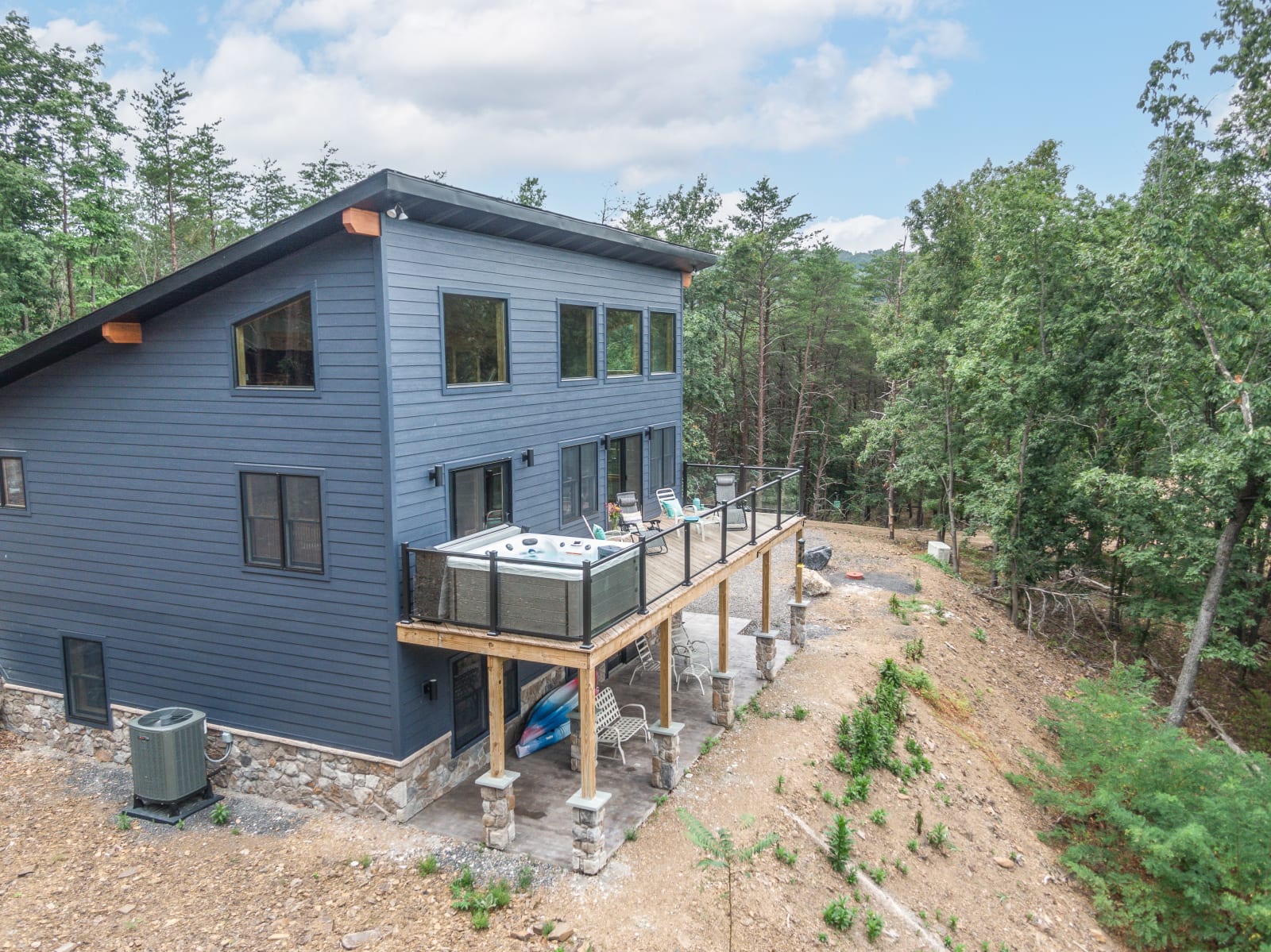 Aerial view of the Britton home and driveway in a wooded mountain setting