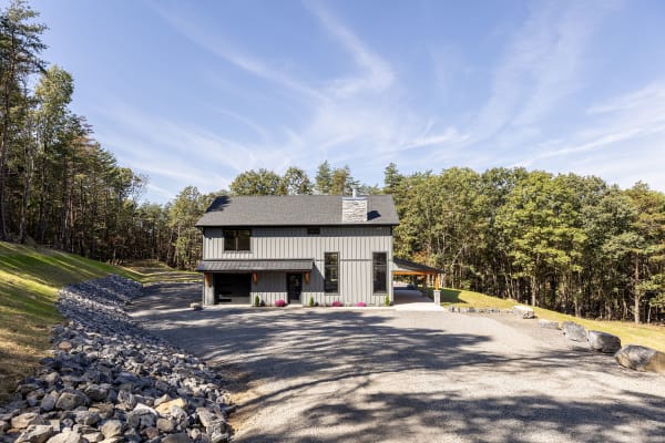 The Bluffs — modern farmhouse with board-and-batten siding and stone chimney