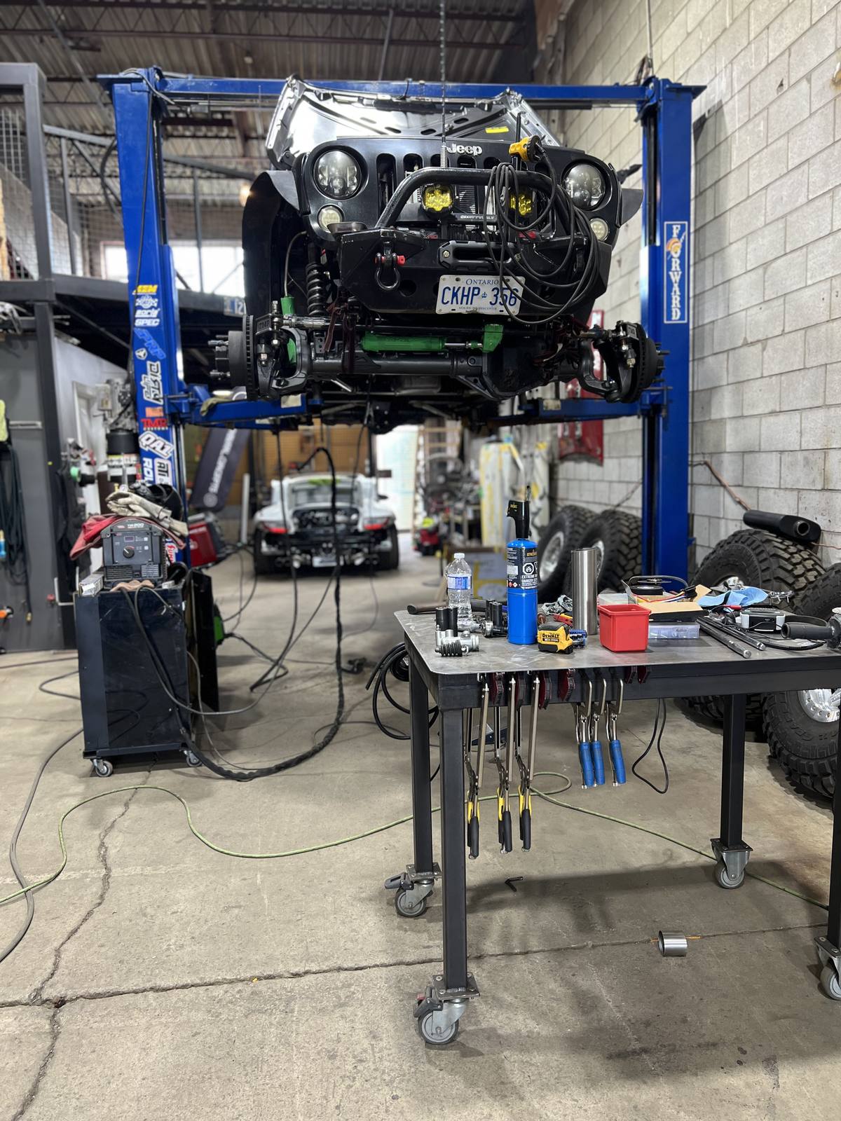 Blackburn Concepts Jeep build — custom fabrication on hoist in Toronto shop