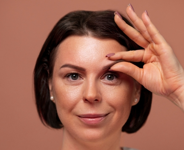 front view woman practicing facial