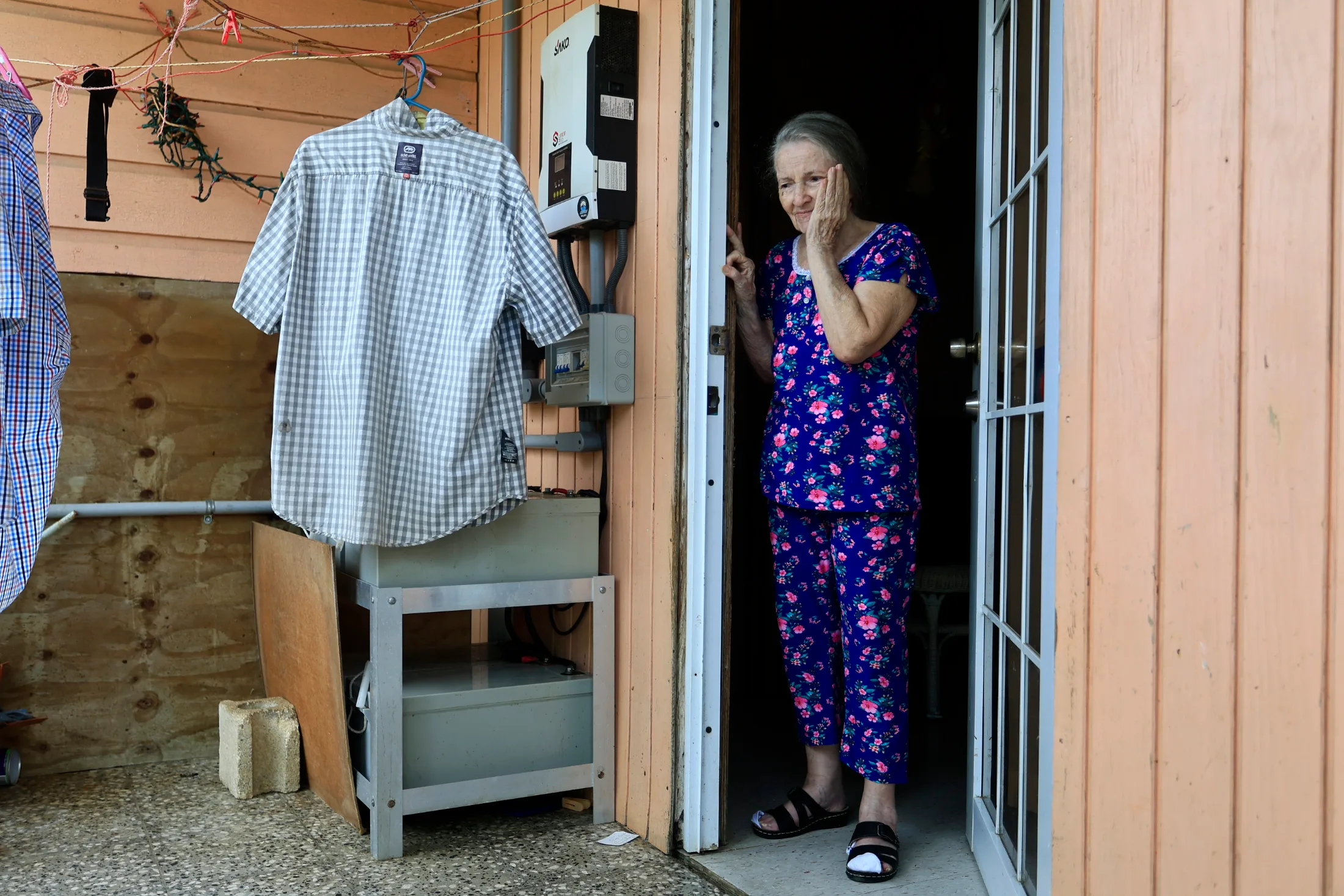 Adjuntas, Puerto Rico, 06/24/2026. Rosa Quintana, 86, shows the batteries of her home's solar system; she is part of the town's solar community. | Thais Llorca for The Parlor Magazine