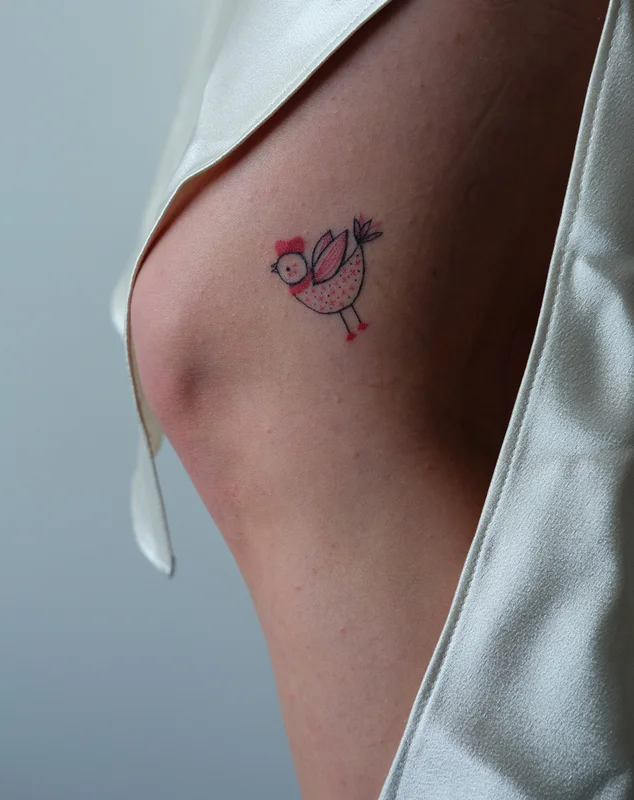 Bird tattoo with Ukrainian ethnic motifs