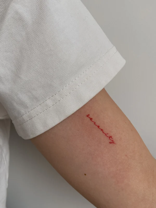 Inscription arm tattoo Serenity