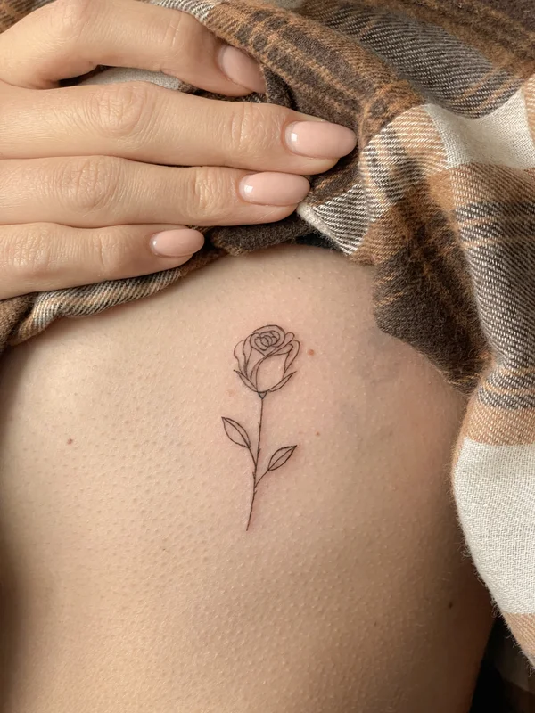 rose mini tattoo on the ribs
