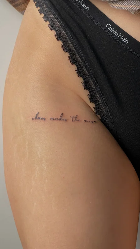script Tattoo on a thigh Chaos makes the muse