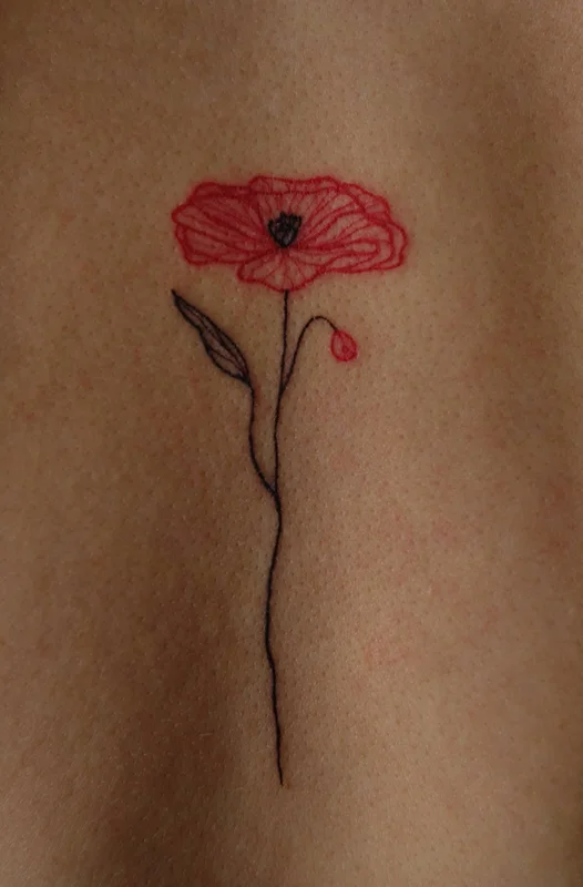 Poppy flower tattoo in red and black