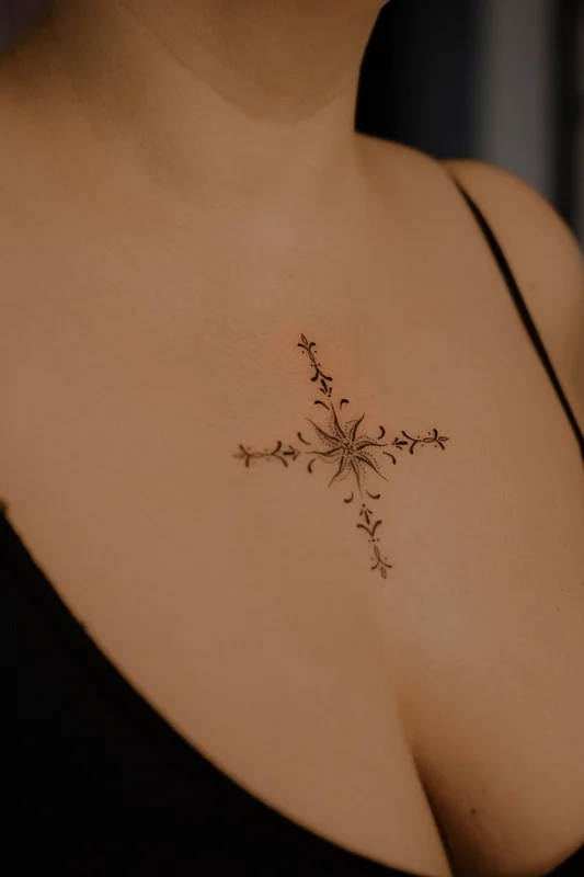 Sun ornament tattoo on chest