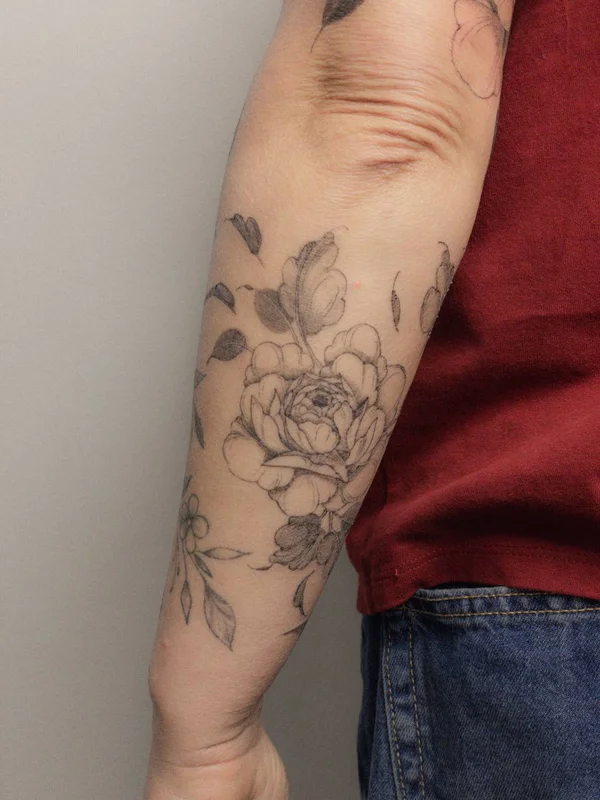 peony tattoo on forearm