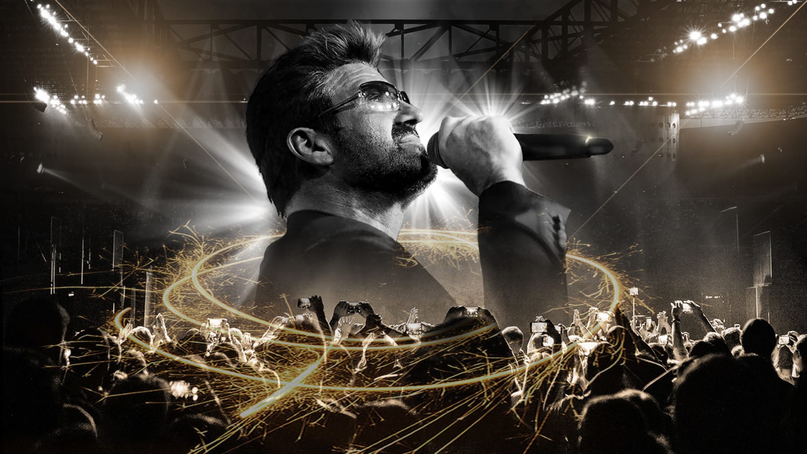 Black and white composite of a male performer singing into a microphone against a crowd of raised hands and bright stage lights, with a swirl of golden sparks encircling the scene