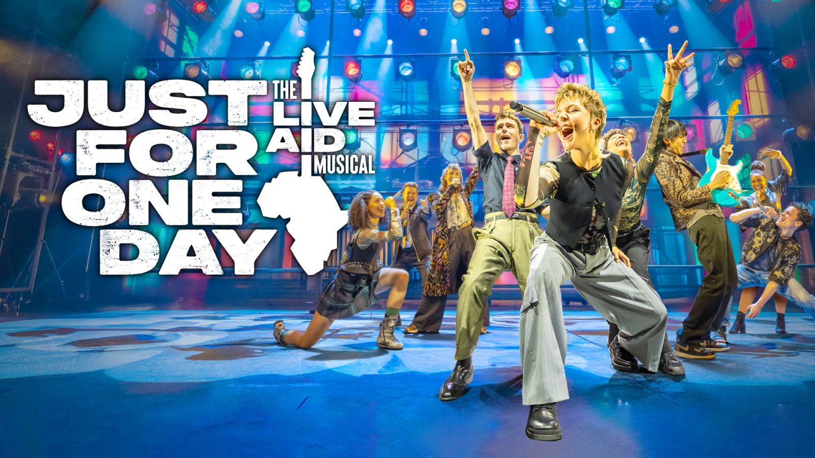 Title card reading 'JUST FOR ONE DAY THE LIVE AID MUSICAL' in bold white lettering with a silhouette of the African continent, over a stage photograph with colourful backlit panels.