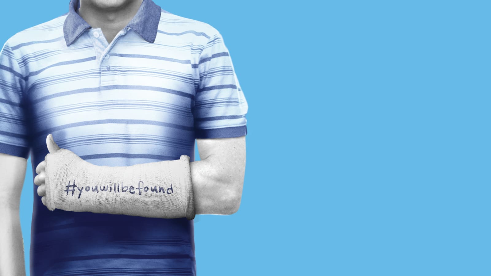 Torso of a figure in a blue-and-white striped polo shirt against a bright blue background, arm in a white plaster cast bearing the handwritten hashtag #youwillbefound
