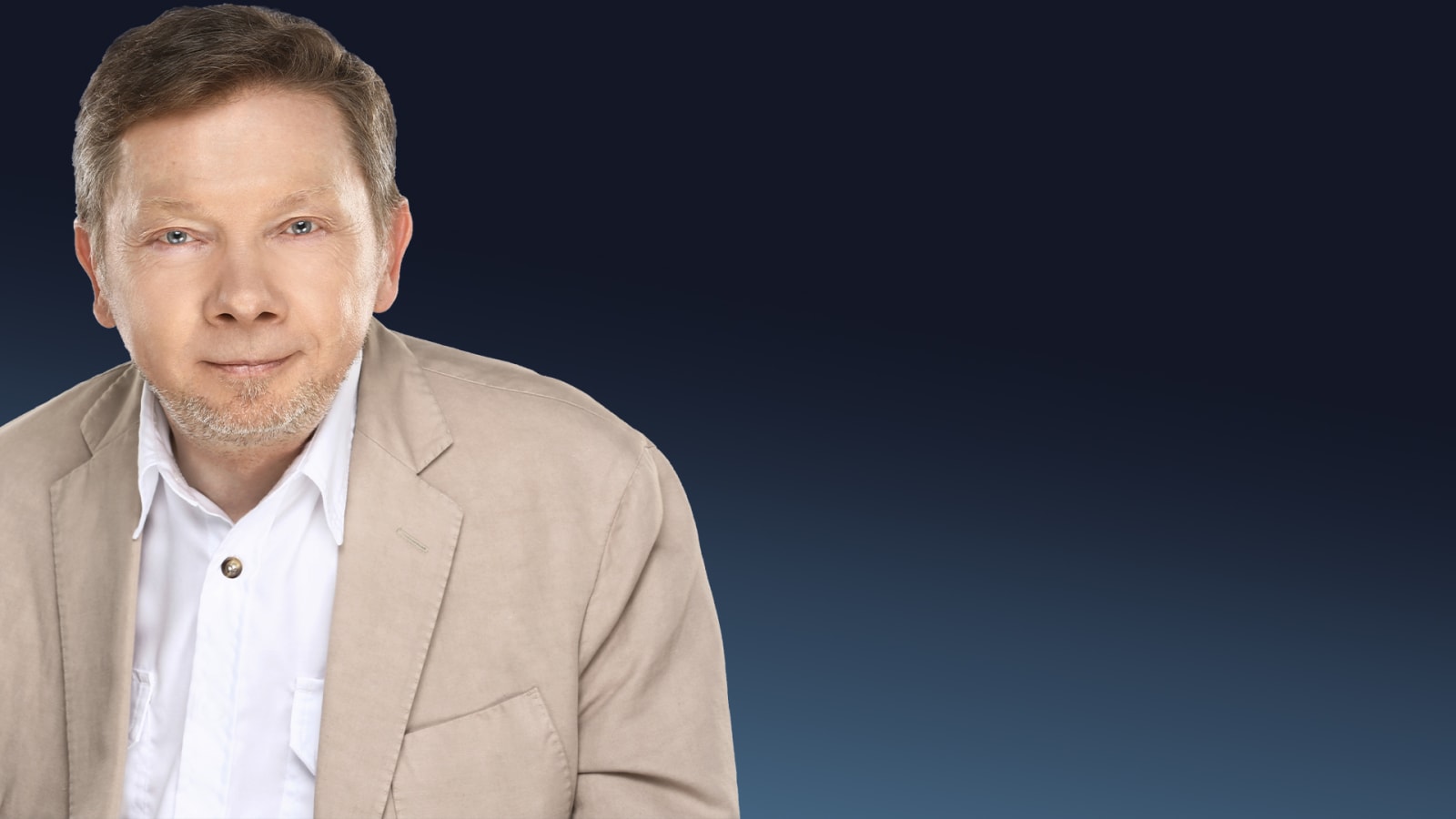A man in a beige blazer and open-collar white shirt against a dark blue gradient background, looking directly at the camera.
