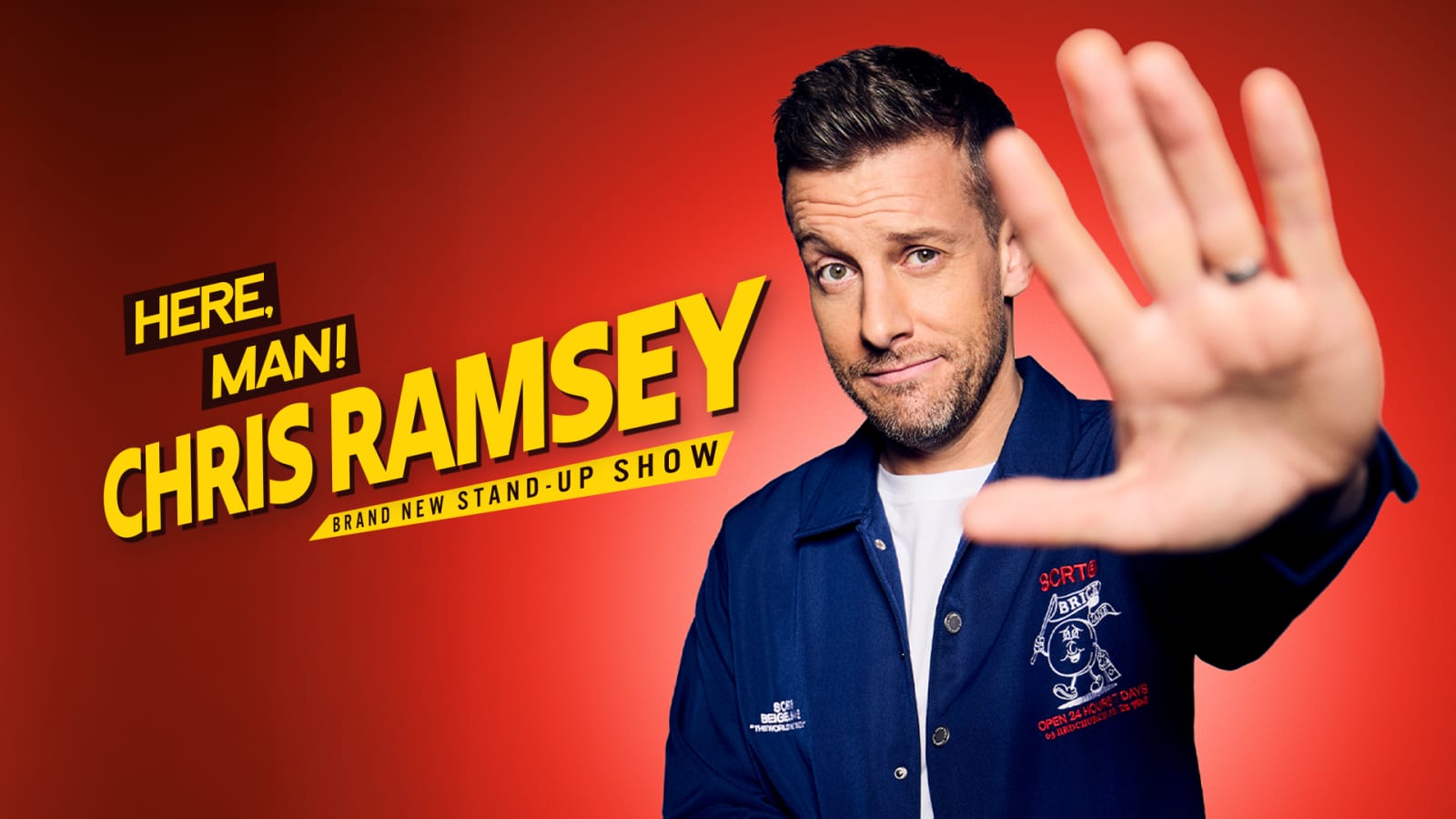 Promotional graphic reading 'HERE, MAN! CHRIS RAMSEY BRAND NEW STAND-UP SHOW' in bold yellow and white text on a red background, with a man in a navy jacket extending one hand toward the camera