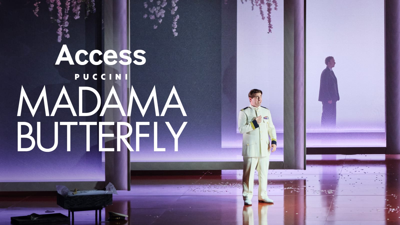 Promotional image with bold white text reading 'Access Puccini Madama Butterfly' overlaid on a purple-lit stage scene showing a performer in a white naval uniform.