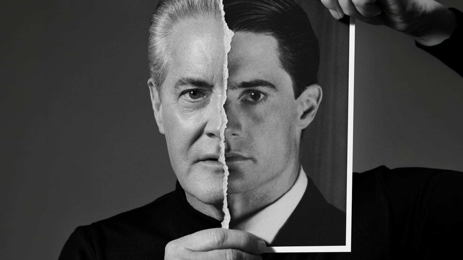 Black and white promotional image of a man holding a torn photograph to his face, aligning one half of the photo with his own features to create a split composite of an older and younger likeness.