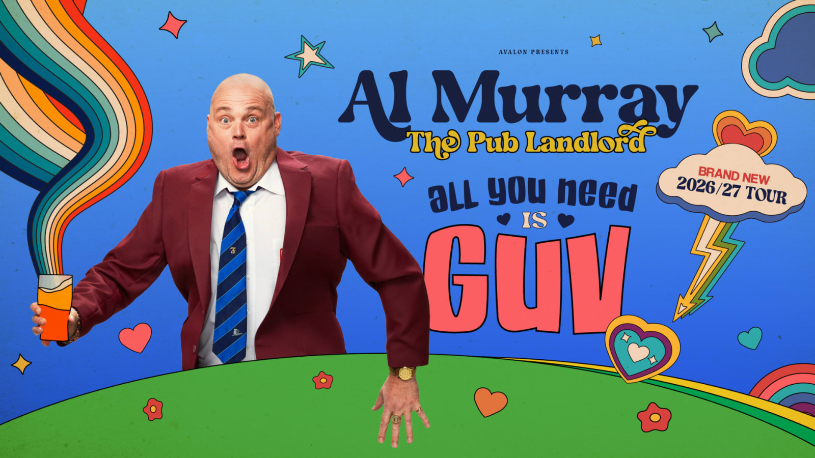 Promotional poster for Al Murray The Pub Landlord: All You Need Is Guv, showing a bald man in a red suit holding an orange cup amid colourful retro rainbows, hearts and stars on a blue background.