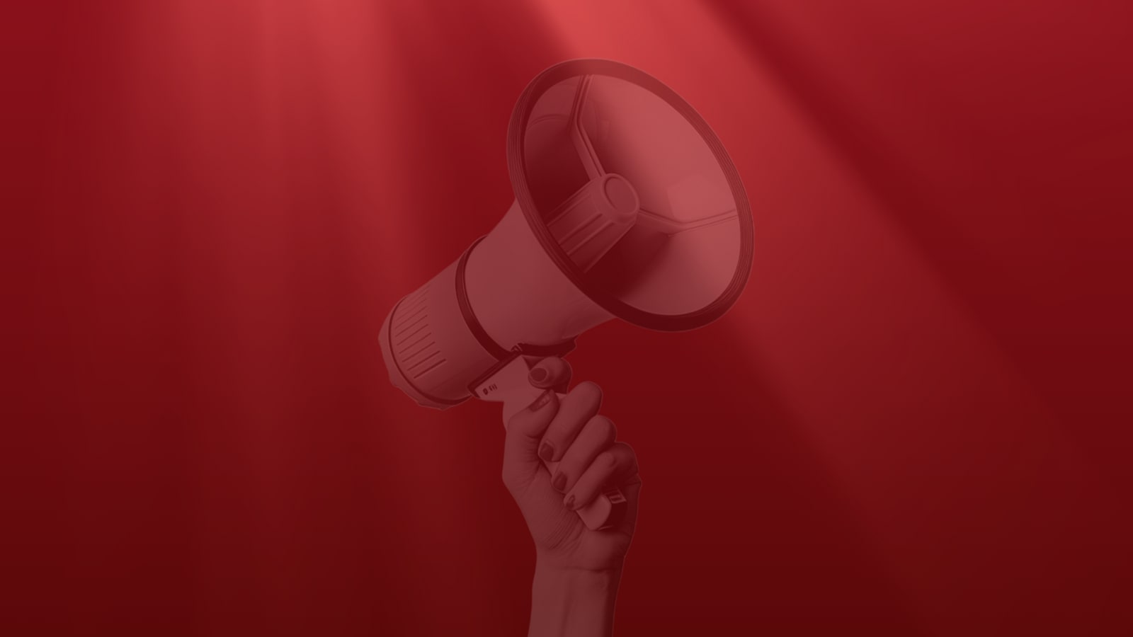 A hand raised against a deep red background, holding a megaphone aloft, bathed in dramatic red-toned lighting
