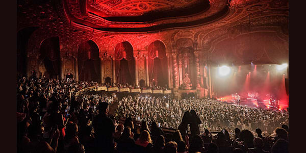 A crowd shot at Kings Theatre during a performance. It is taken from the top mezzanine level to a full crowd.