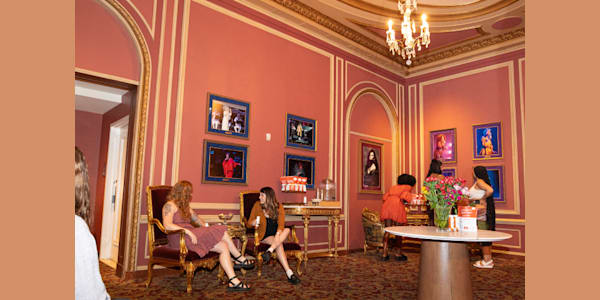 Patrons inside the Queens Lounge at Kings Theatre enjoying various amenities offered in this premium and historic space. 