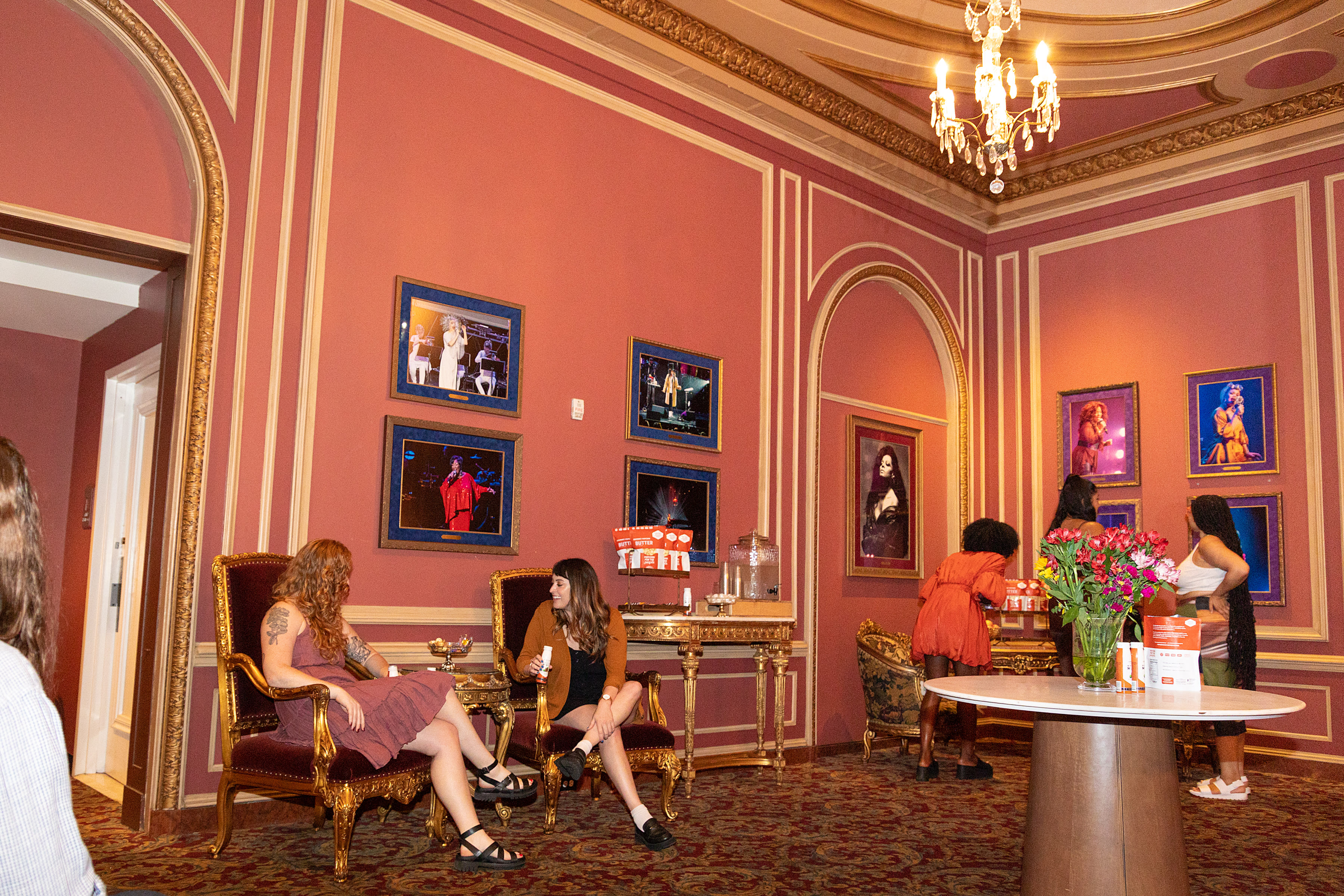 Patrons inside the Queens Lounge at Kings Theatre enjoying various amenities offered in this premium and historic space. 
