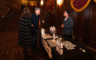 Audience members in the lobby of Kings Theatre interacting with a sponsor on site. 